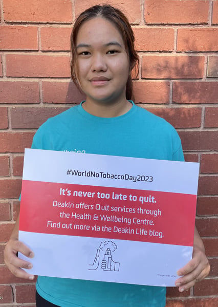 Wellbeing Ambassador holding up a sign for World No Tobacco Day 2023