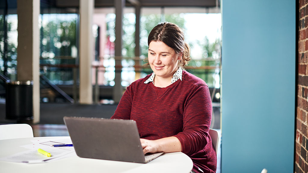 Female student working on laptop