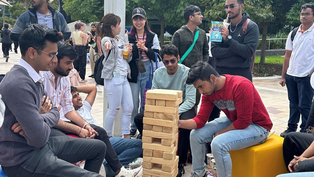Students attempting a large Jenga puzzle at Burwood Campus