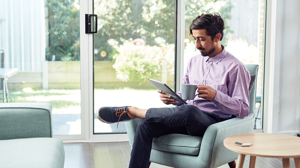 Male student using tablet at home