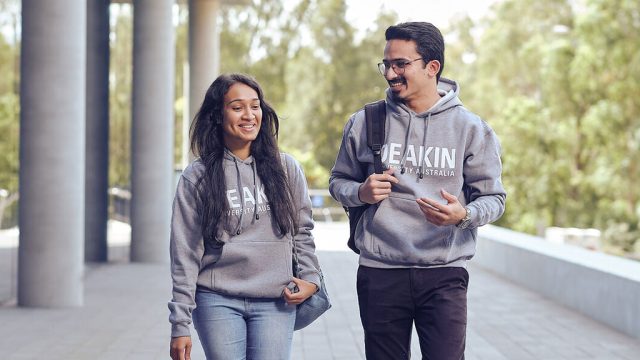 Two Deakin students in branded hoodies