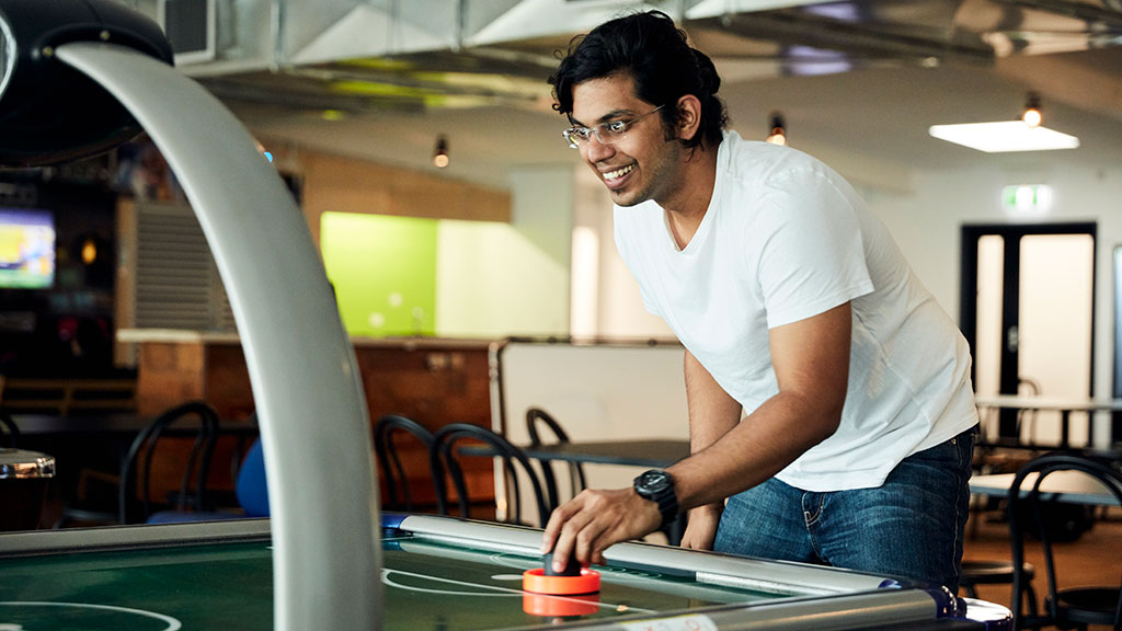 Student playing air hockey on Res