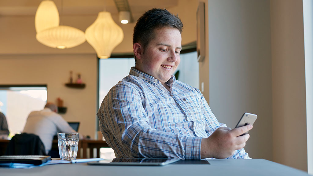 Male student looking at phone