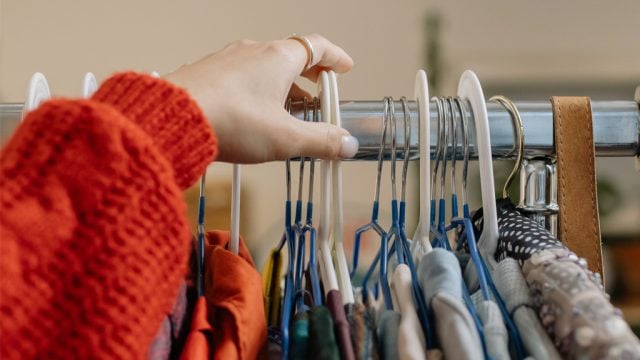 Woman browsing clothing rack