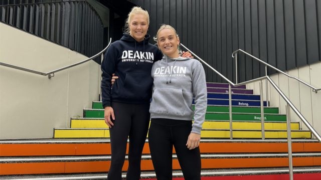Netballers and Deakin students Kate Moloney and Liz Watson on the Pride Stairs at Burwood Campus