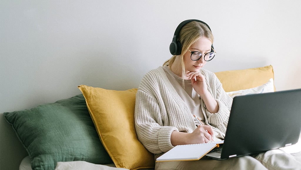 Female studying on lap top with headphones