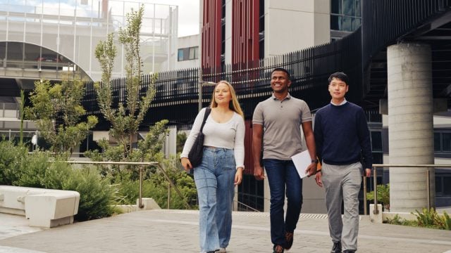 Three students walking together through Burwood Campus