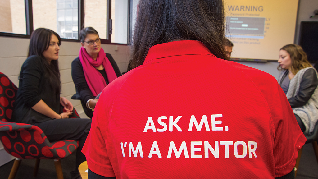 A close up on a mentor's shirt reading 'Ask me. I'm a mentor'