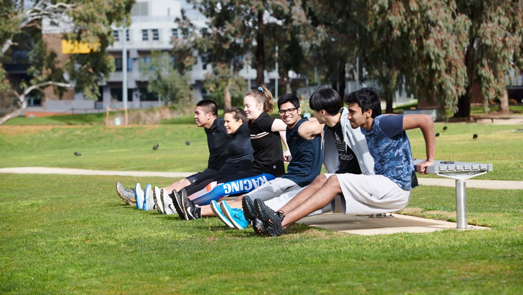 Students exercising outside in a group fitness class at Waurn Ponds
