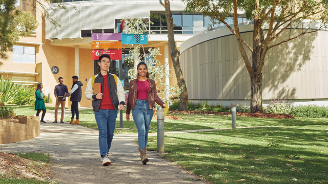 Students walking happily on campus