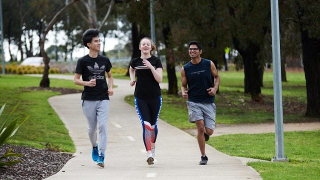 Three students running along track at Waurn Ponds