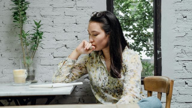 Woman looking worried while sitting at table