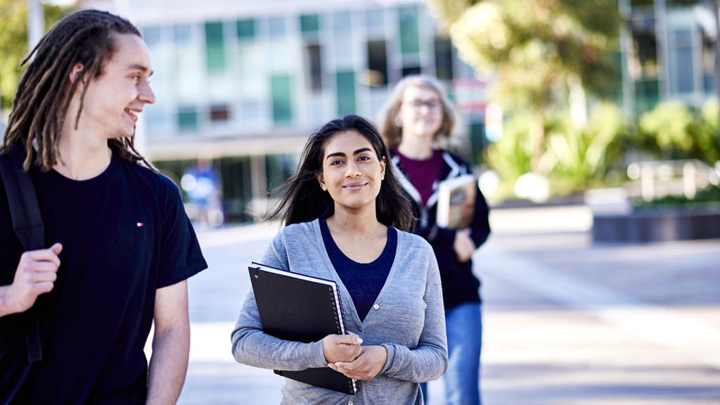 Student smiles as she walks through Burwood Campus with other students