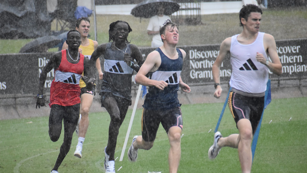 Riley Bryce (in white) leading the race featuring Peter Bol (in red)