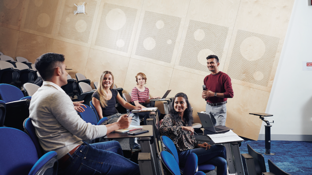 Students sitting and discussing in a lecture hall