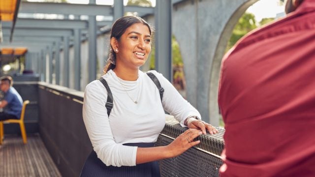 Student smiling as she cats to peer outside at Waurn Ponds Campus