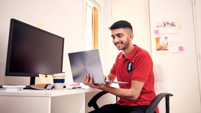 Student looking at computer at home