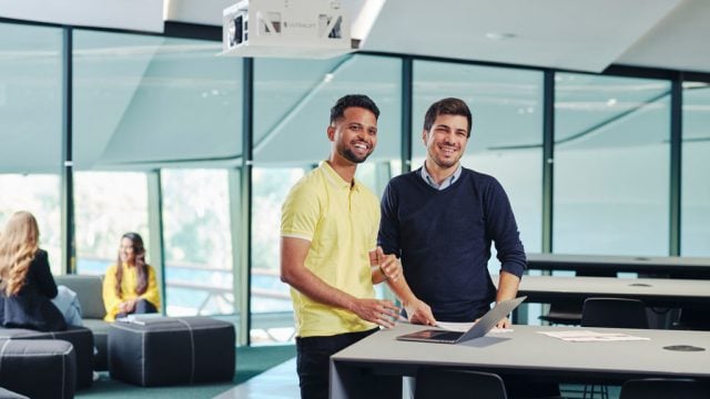 Two students standing together by a table at Burwood Campus