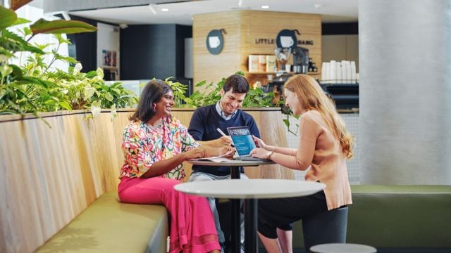 Students sitting and chatting together at table at Burwood Campus