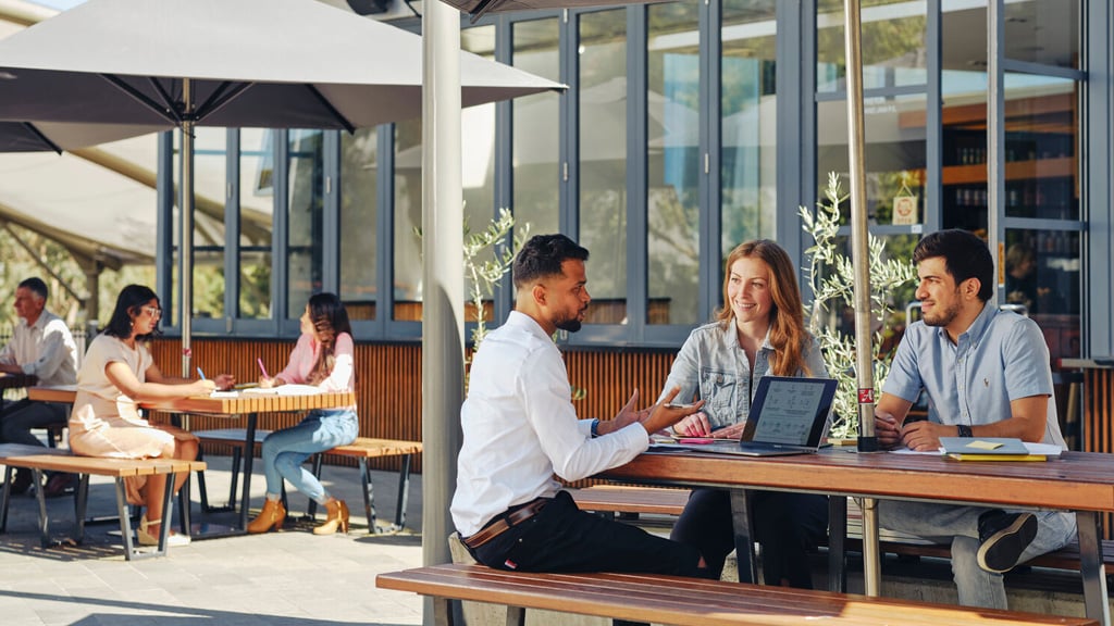 Students chatting in outdoor dining area