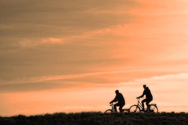Silhouette of two cyclists in the sunset