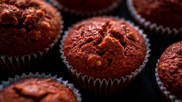 Close-up of freshly baked beetroot muffins in wrappers.