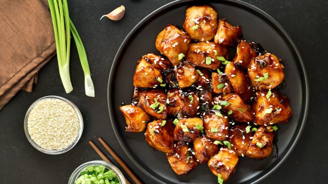 Cooked chicken covered in teriyaki sauce.